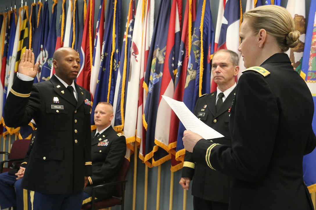 Four Virginia Army National Guard officer candidates pin on second lieutenant rank at a graduation and commissioning ceremony held April 12, 2013, at the 183rd Regiment, Regional Training Institute at Fort Pickett. The officers of OCS Class 57A completed the eight-week Accelerated OCS Course at Ft. McClellan, Ala., to earn their commissions. Col. Doug Messner, commander of 183rd RTI, gave the remarks at the ceremony, and Maj. Gen. Daniel E. Long, Jr., the Adjutant General of Virginia, presented each candidate with a framed diploma. Each candidate selected who would administer their oath of office, pin on their rank shoulder boards and the NCO to receive their first salute and sliver dollar. The silver dollar salute is an Army tradition that newly commissioned second lieutenants present a silver dollar to the first enlisted Soldier who salutes them. The coin symbolically acknowledges the receipt of respect due the new rank and position. (Photo by Cotton Puryear, Virginia National Guard Public Affairs)