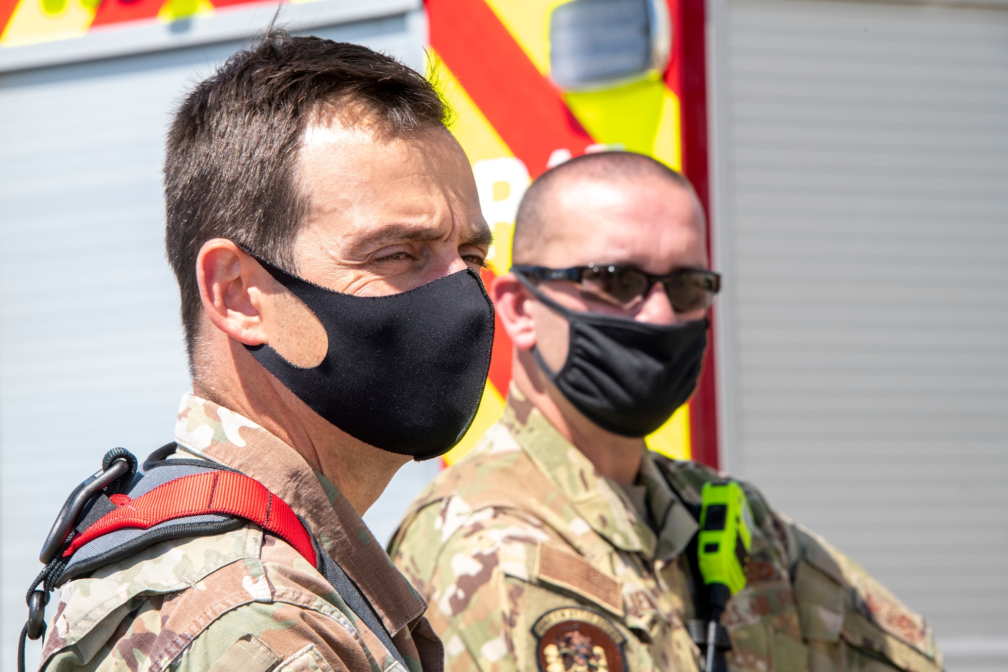 U.S. Air Force Lt. Col. Matthew Suhre, left, 60th Mission Support Group deputy commander and Master Sgt. Jeffrey Trueman, 60th Civil Engineer Squadron deputy fire chief, observe training activities April 19, 2021, at Travis Air Force Base, California. Suhre and Trueman were participating in a training demonstration that provided senior leadership with a clear picture of the technical rescue capabilities for multi-story building and confined space rescues conducted by Travis AFB emergency response personnel. (U.S. Air Force photo by Heide Couch)