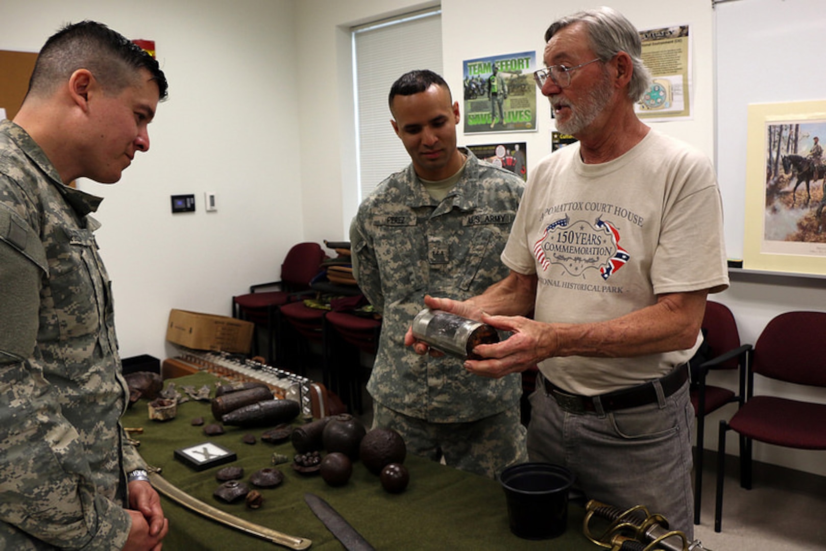 Virginia Army National Guard Officer Candidates hold history in their hands during a military history course April 19, 2015, at the Fort Pickett-based 183rd Regiment, Regional Training Institute. Taught by Col. Thomas L. Morgan III, commander of the 183rd Regional Training Institute, the class included demonstrations on the loading and operating procedures for dozens of Civil-War era rifles and pistols, and displays of Civil War artifacts from the personal collections of Morgan and his father, Thomas L. Morgan Jr. After the classroom portion of the course, the candidates were able to pick and examine the pieces for a closer look. (Photo by Staff Sgt. Miko M. Skerrett, Virginia Guard Public Affairs)