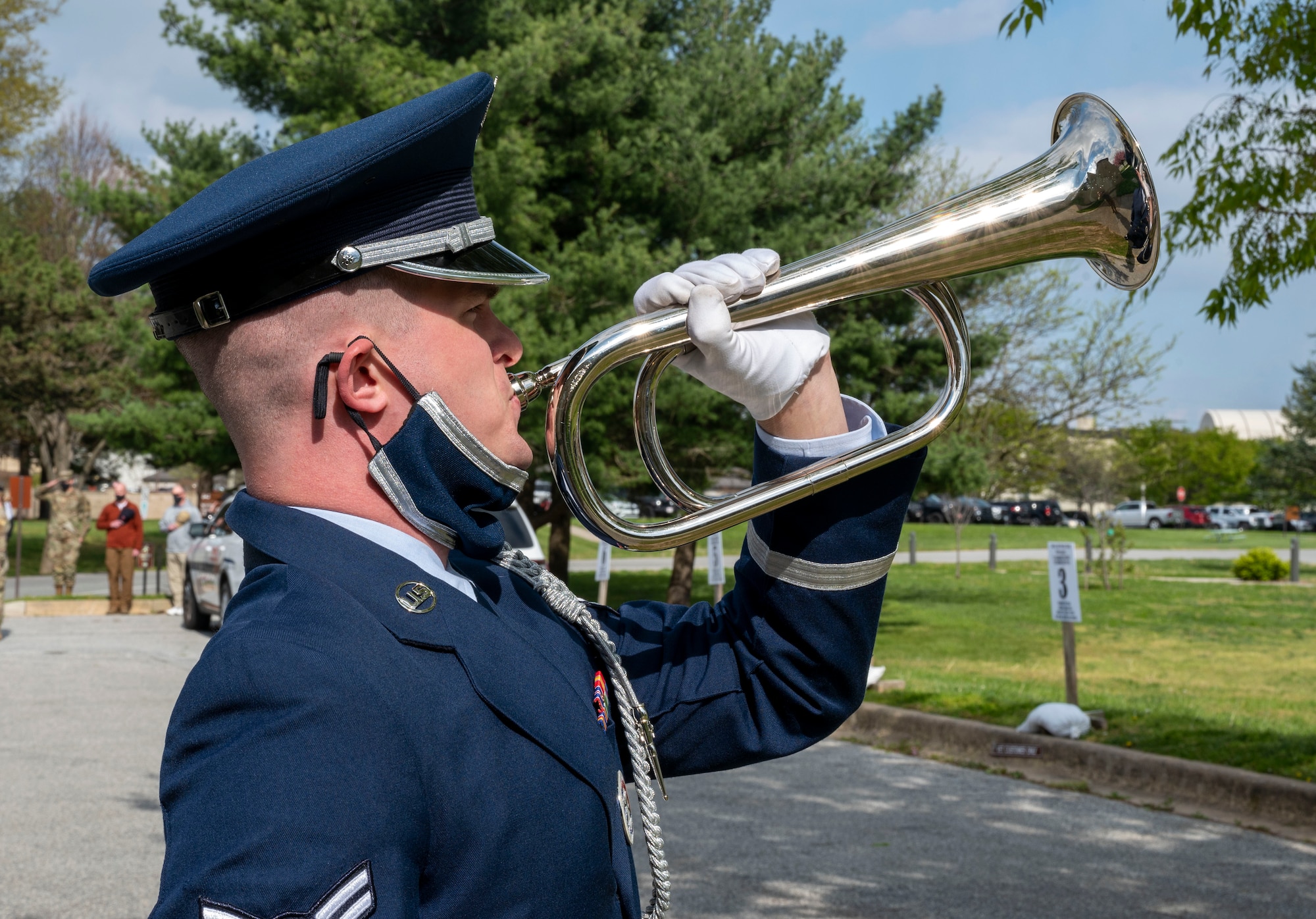 Airman 1st Class Owen McAvoy, 436th Force Support Squadron honor guard member, plays taps during retired Military Working Dog Kali’s last call at the veterinary treatment facility on Dover Air Force Base, Delaware, April 22, 2021. The last call is a ceremony used to show respect and bid farewell to a fallen police officer or MWD. Following seven years of service, Kali was humanely euthanized after suffering from a tumor in her abdomen. (U.S. Air Force photo by Airman 1st Class Cydney Lee)