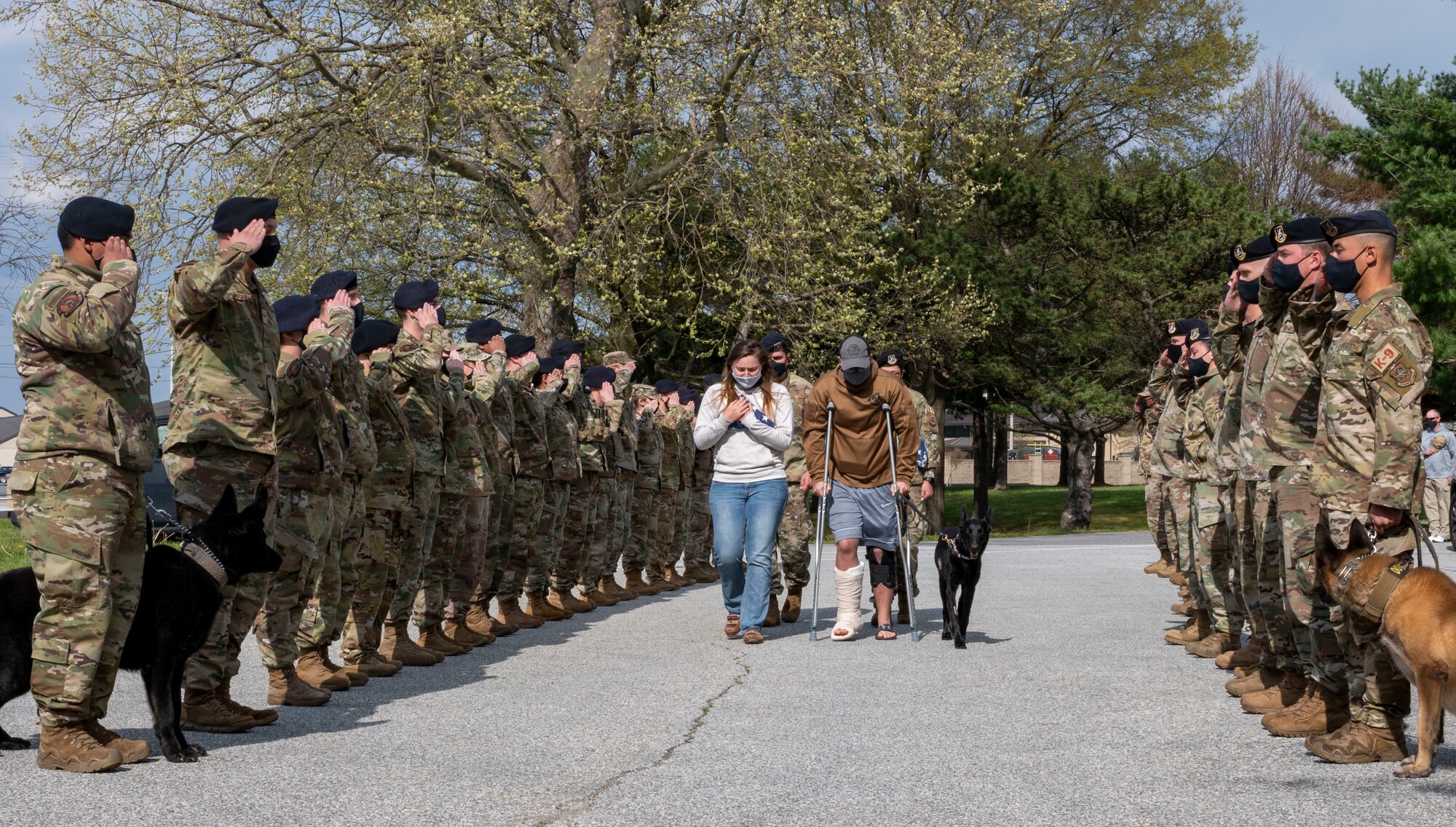 Staff Sgt. Brandon Soto, 436th Security Forces Squadron military working dog handler, and his wife, Emily Soto, walk retired MWD Kali during her last call at Dover Air Force Base, Delaware, April 22, 2021. The last call is a ceremony used to show respect and bid farewell to a fallen police officer or MWD. Following seven years of service, Kali was humanely euthanized after suffering from a tumor in her abdomen. (U.S. Air Force photo by Airman 1st Class Cydney Lee)