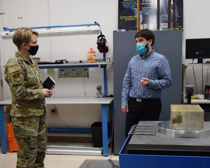 Mr. Chris Lomanno, research engineer, discusses AFIT’s vibration table with Brig. Gen. Linell Letendre, dean of faculty, USAFA.  AFIT’s Center for Space Research and Assurance focuses on the evolution of defense and intelligence missions in space.