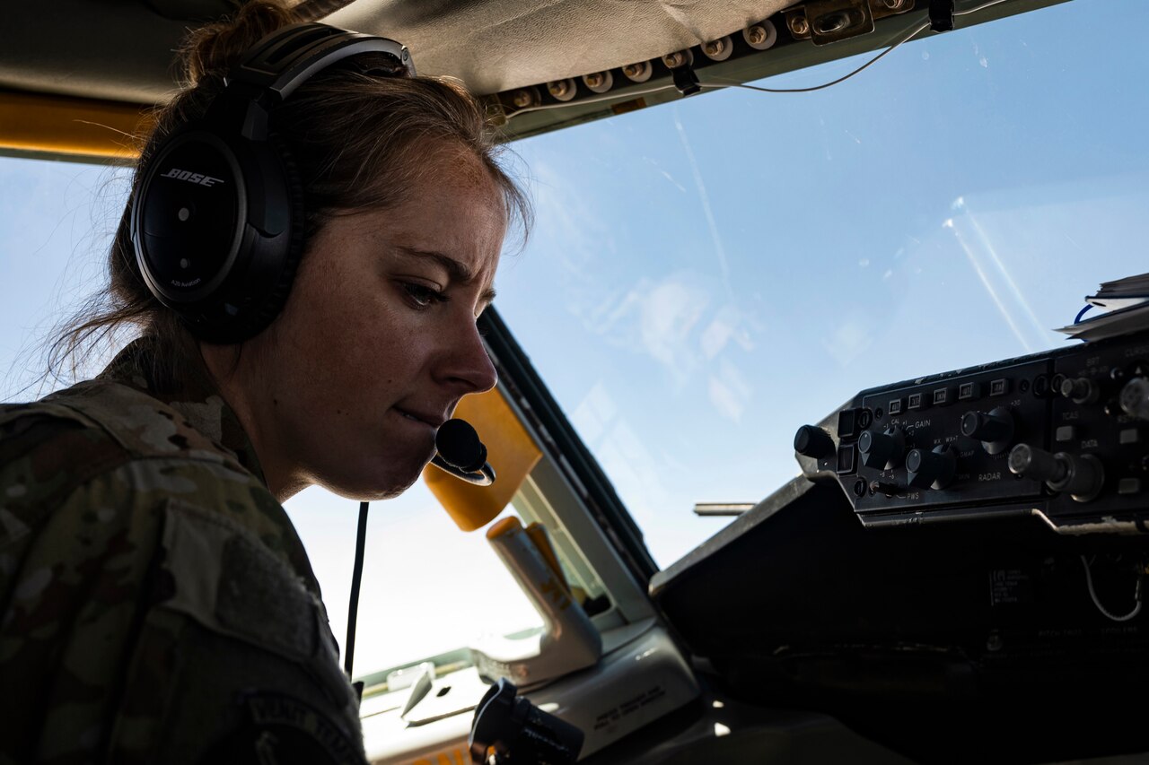 A female pilot flies an aircraft.