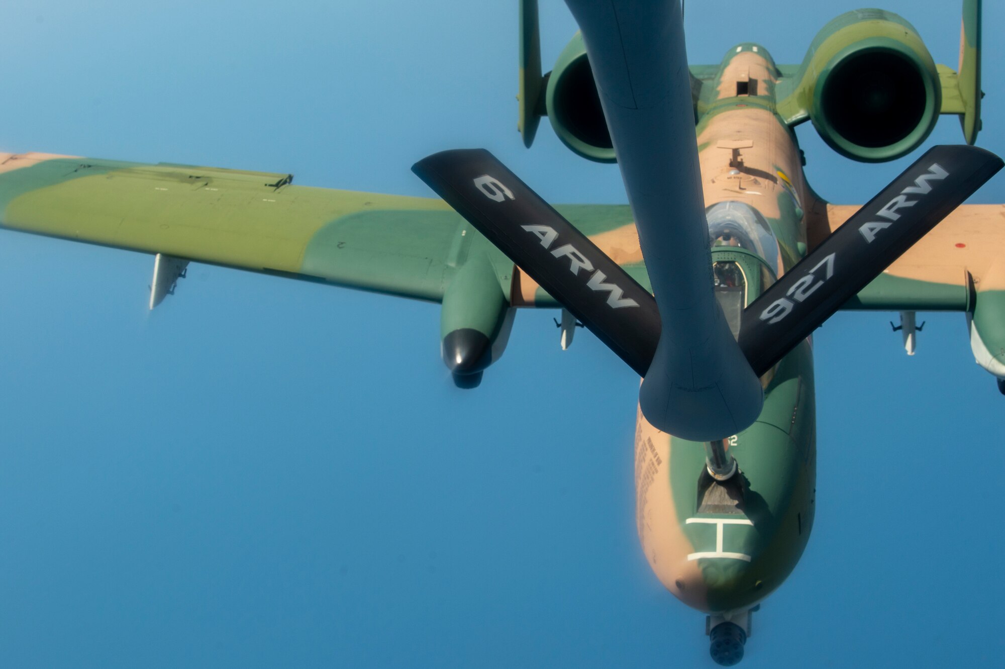 A KC-135 Stratotanker aircraft from MacDill Air Force Base, Fla., refuels an A-10 Thunderbolt II aircraft, April 18, 2021. The A-10 was painted in a Southeast Asia camouflage scheme as a tribute to the 355th Tactical Fighter Wing. (U.S. Air Force photo by Airman 1st Class David D. McLoney)
