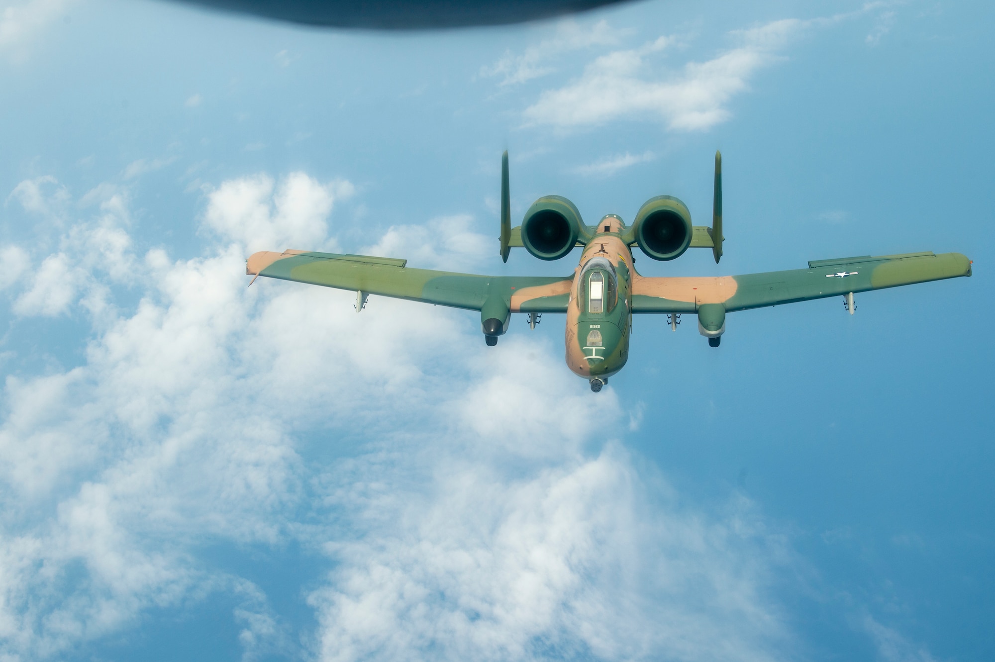 An A-10 Thunderbolt II aircraft flies through the air after being refueled by a KC-135 Stratotanker from MacDill Air Force Base, Fla., April 18, 2021. The A-10 performed during the SUN ‘n FUN Aerospace Expo earlier that day, during a heritage flight with an F-22 Raptor aircraft and a P-51 Mustang aircraft. (U.S. Air Force photo by Airman 1st Class David D. McLoney)