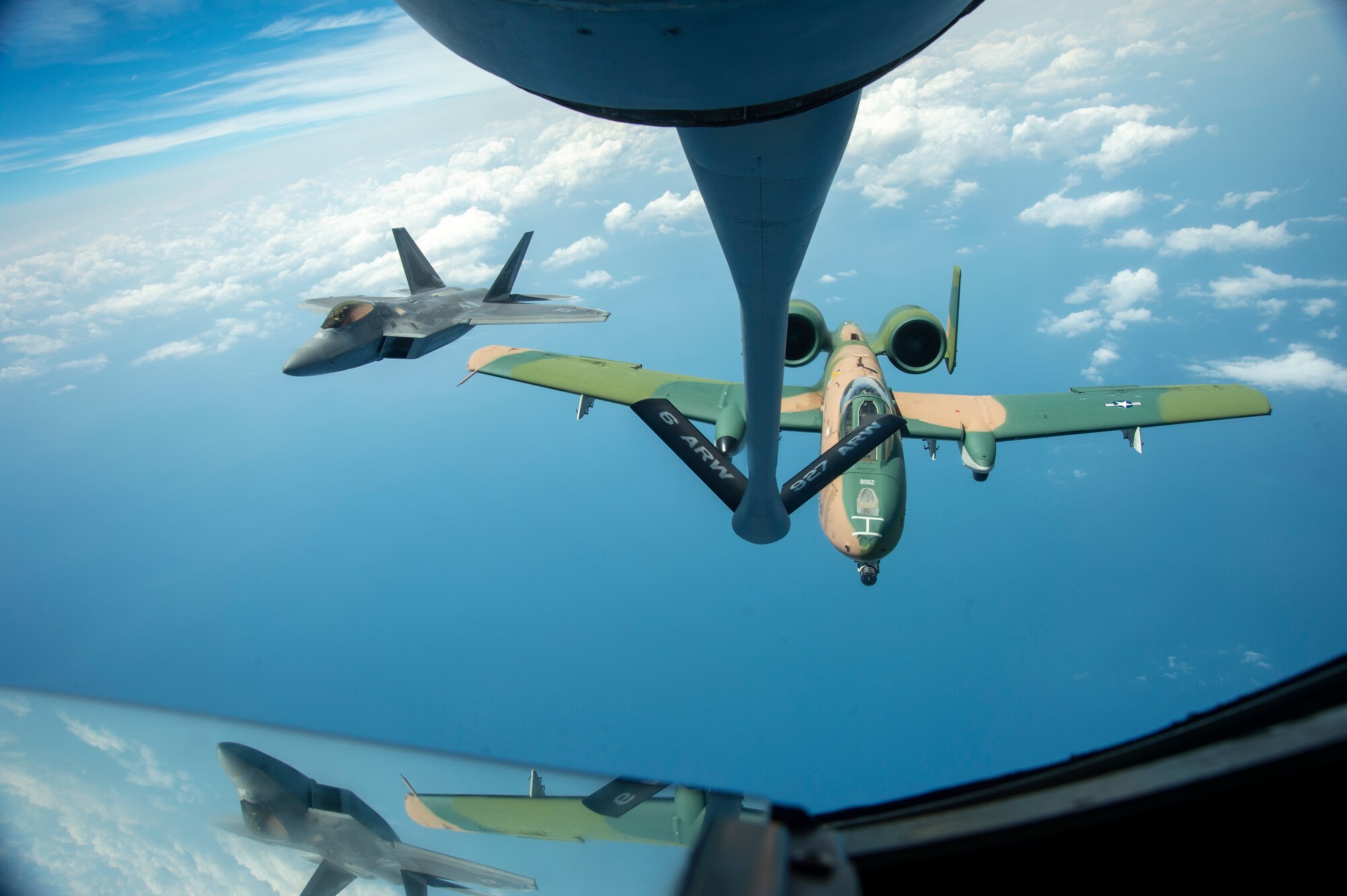 An F-22 Raptor aircraft and an A-10 Thunderbolt aircraft II fly through the air after being refueled by a KC-135 Stratotanker from MacDill Air Force Base, Fla., April 18, 2021, after performing for the SUN ‘n FUN Aerospace Expo located in Lakeland, Fla. The Expo is the second largest air show in the world, with over 225,000 enthusiasts visiting to experience the 377 exhibitors that participated in the event. (U.S. Air Force photo by Airman 1st Class David D. McLoney)