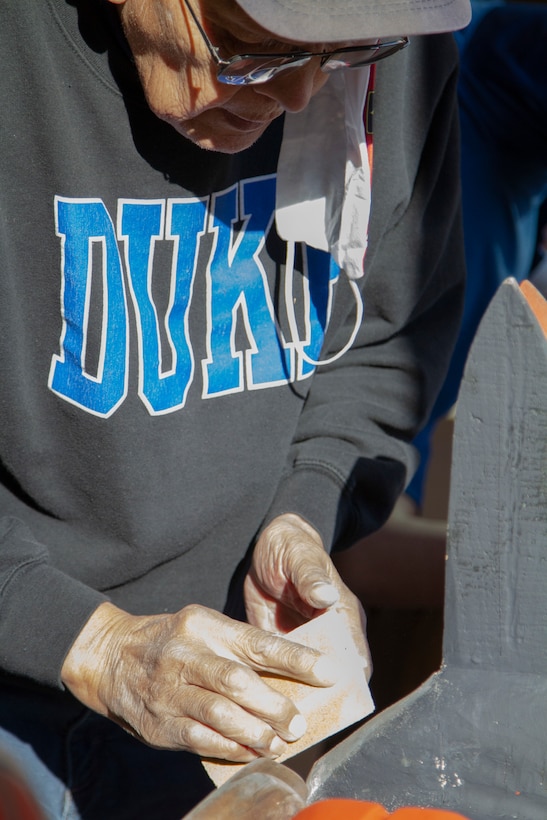 George Bennett restores the 11.5-foot honor pole that sits in front of the Alaska National Guard armory April 17, 2021, on Joint Base Elmendorf-Richardson after 12 years since originally carving it with his son. The pole was originally built in Sitka and serves as a monument dedicated to the profound contributions of the Alaska Natives to the safety and heritage of the state in the past and present. (U.S. Army National Guard photo by Spc. Grace Nechanicky)