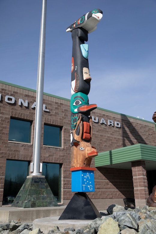 The honor pole that was built by George and James Bennett, a father-son duo from Sitka, sits in front of the Alaska Army National Guard armory April 27, 2021, days after it was restored. The pole is a momument that was built in 2007 and 2008, and is dedicated to the profound contributions of the Alaska Natives to the safety and heritage of the state in the past and present. (U.S. Army National Guard photo by Spc. Grace Nechanicky)