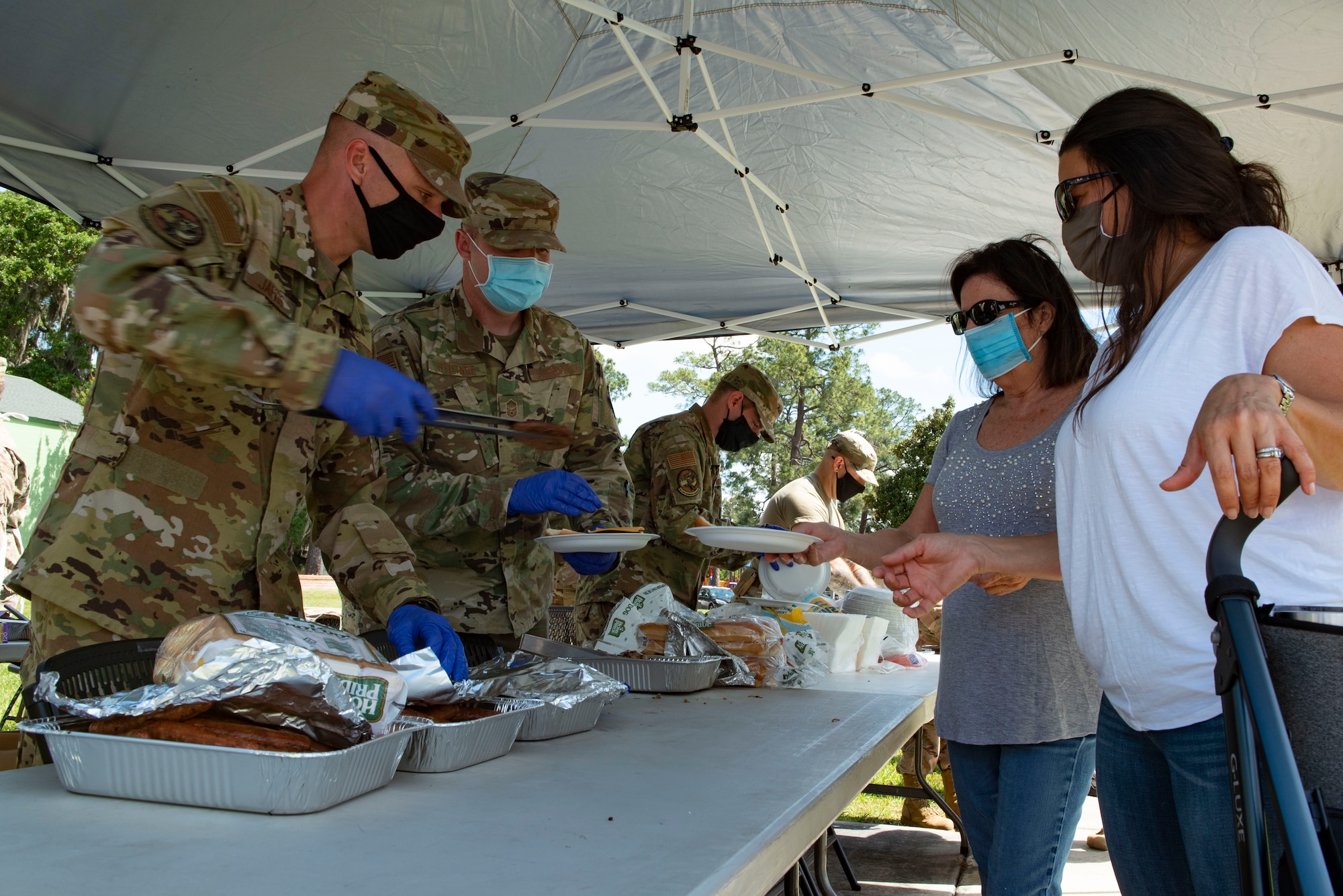 A photo of Airmen serving food to people.