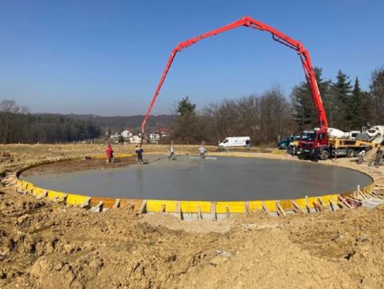 Crews pour concrete at the site for a new helicopter landing zone at the primary hospital in Karlovac, Croatia in March 2021 as part of a project being managed by the U.S. Army Corps of Engineers, Europe District in support of the U.S. European Command and in close coordination with the U.S. Embassy in Croatia. The site is one of three helicopter landing zones being built to improve local emergency medical response capabilities and help save lives. (Courtesy Photo)