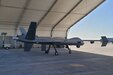 A drone sits inside a hangar.