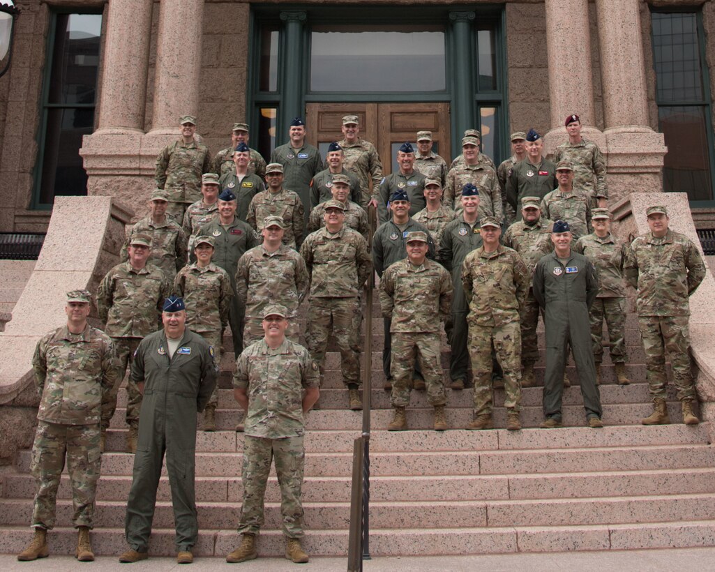 Members of 10th Air Force took a break during the 2021 Commanders and Command Chiefs Conference to take a photo in front of the Fort Worth Courthouse.