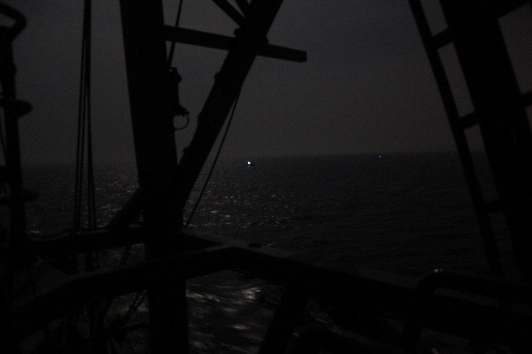 210426-N-NO146-1004 ARABIAN GULF (April 26, 2021) Three Iranian Islamic Revolutionary Guard Corps Navy (IRGCN) fast inshore attack craft (FIAC) approach the patrol coastal ship USS Firebolt (PC 10), while the U.S. vessel was conducting routine maritime security patrols in the international waters of the North Arabian Gulf, April 26. Firebolt is assigned to U.S. Naval Forces Central Command’s Task Force (TF) 55. (U.S. Navy Photo)