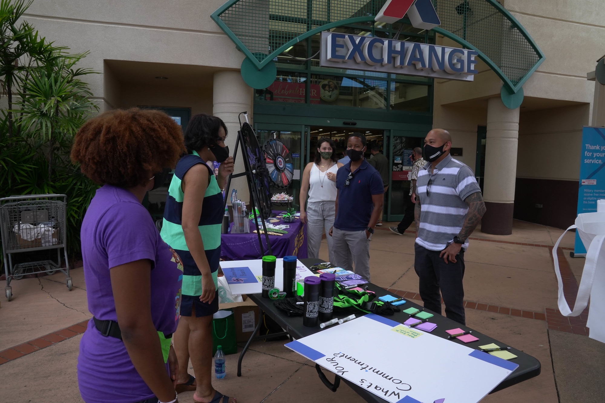 Sexual Assault Prevention and Response and Suicide Prevention facilitators speak to military members and their families at a booth at the Hickam Main Exchange at Joint Base Pearl Harbor-Hickam, Hawaii, April 23, 2021. In honor of Child Abuse Prevention Month and the Month of the Military Child, military members and their families shared and received ideas to build stronger and healthier relationships with their children. (U.S. Air Force photo by Airman 1st Class Makensie Cooper)