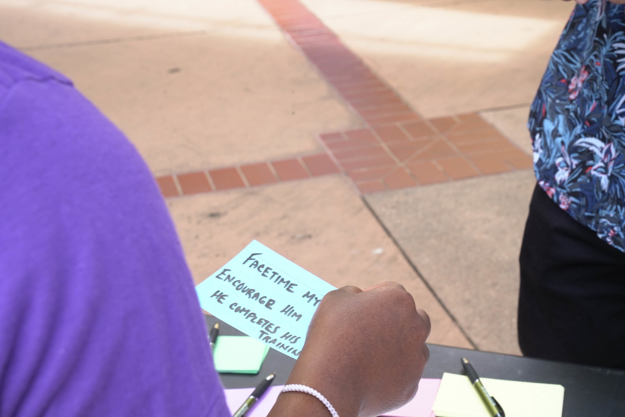 Marrisa Toppin, Sexual Assault Prevention and Response and Suicide Prevention facilitator, receives a commitment card from a military parent with an idea of how to build a better relationship with their children at the Hickam Main Exchange at Joint Base Pearl Harbor-Hickam, Hawaii, April 23, 2021. In honor of Child Abuse Prevention Month, military members and their families shared and received ideas to build stronger and healthier relationships with their children. (U.S. Air Force photo by Airman 1st Class Makensie Cooper)