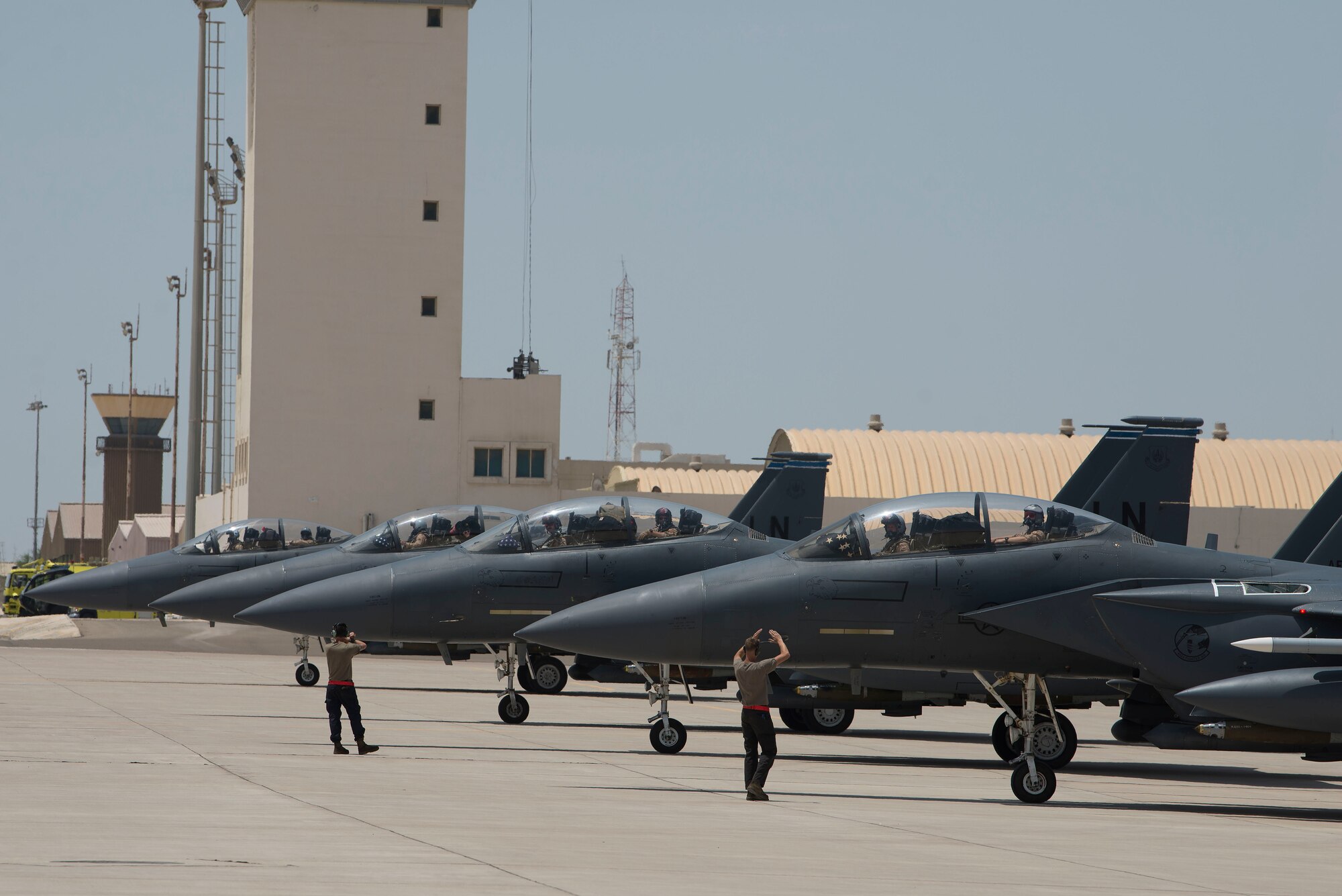 Four F-15E Strike Eagles assigned to the 494th Expeditionary Fighter Squadron (EFS) line up on the flightline at Al Dhafra Air Base, United Arab Emirates, April 25, 2021.