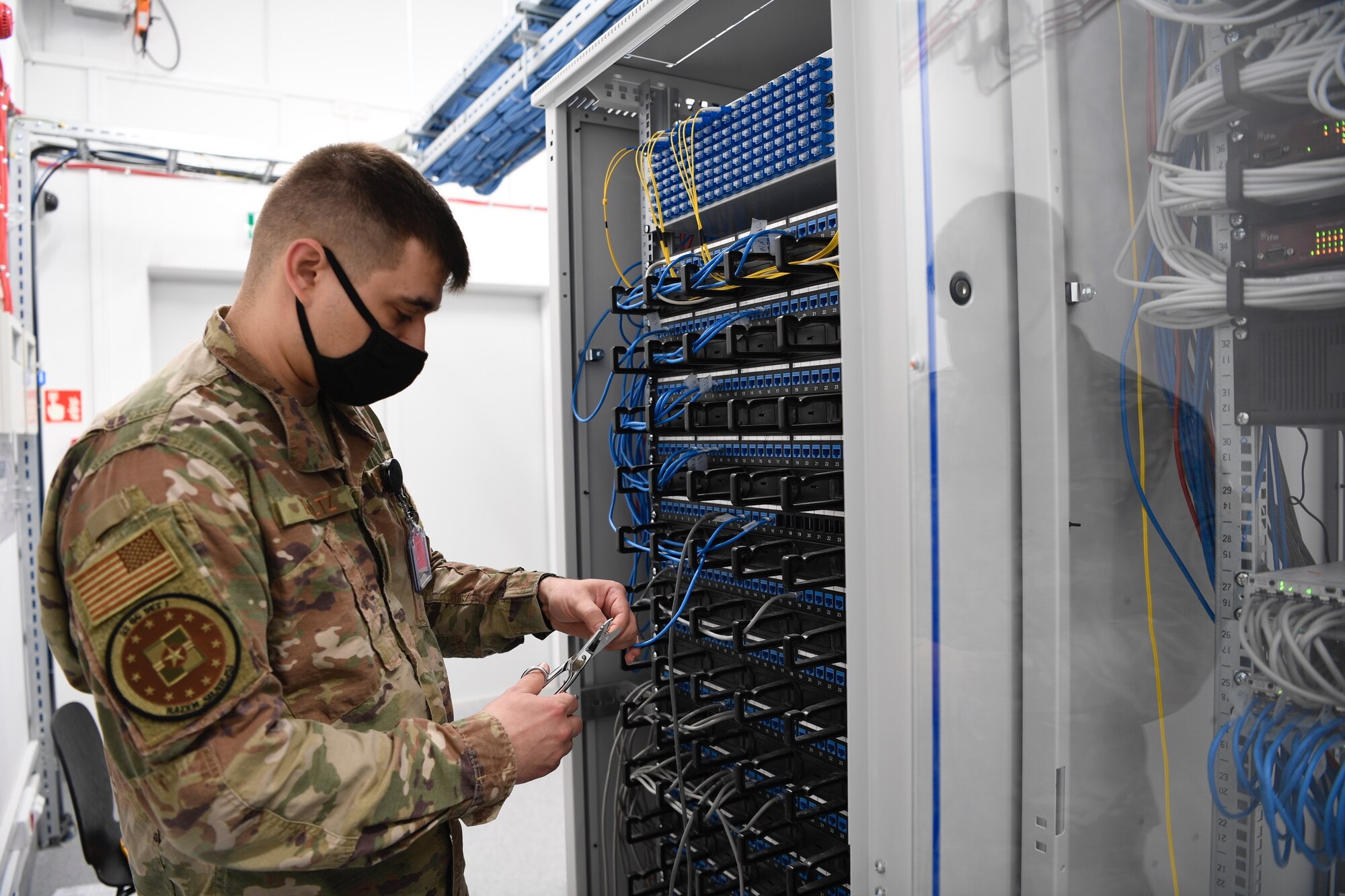 U.S. Air Force Tech. Sgt. Lance Baltz, 52nd Operations Group Detachment 1 client support systems technician, works on a server at Łask Air Base, Poland, April 21, 2021. Baltz, as a CSS technician, ensures that all of the computer hardware and software function correctly at Det 1. (U.S. Air Force photo by Tech. Sgt. Warren D. Spearman Jr.)