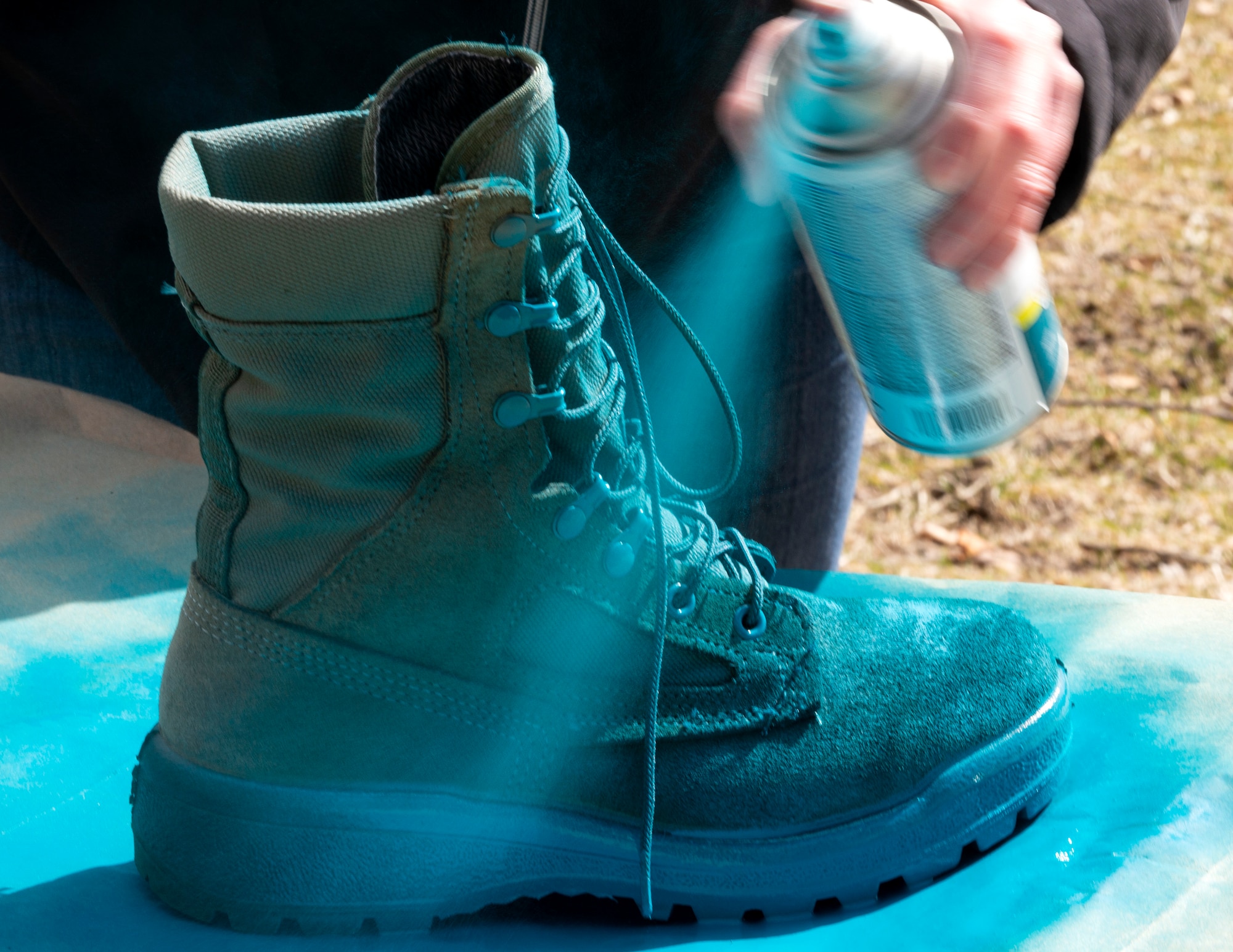 Krista Sheridan, 133rd Sexual Assault Response Coordinator, paints combat boots teal in St. Paul, Minn., Mar. 31, 2021.