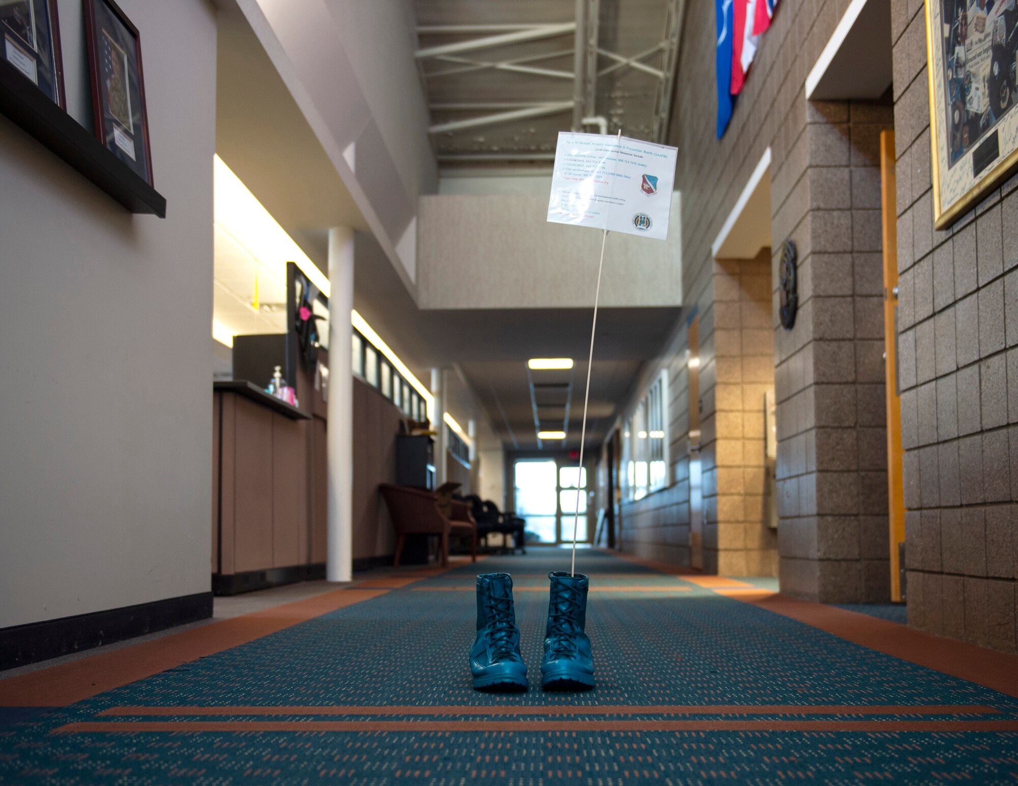 Krista Sheridan, 133rd Sexual Assault Response Coordinator, paints combat boots teal in St. Paul, Minn., Mar. 31, 2021.