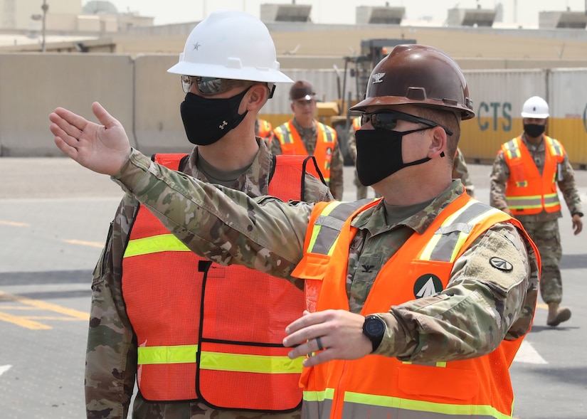 Col. Michael Ludwick, commander of 595th Transportation Brigade (SDDC), gestures while he describes port operations to Brig. Gen. Justin M. Swanson, the deputy commanding general of the 1st Theater Sustainment Command, while on Swanson's April 24, 2021 tour of Kuwait's Port Shuaiba. The 595th TB (SDDC) integrates and synchronizes surface deployment and distribution capabilities to project readiness and sustain the warfighter throughout the U.S. Central Command area of operations. (U.S. Army photo by Staff Sgt. Neil W. McCabe)