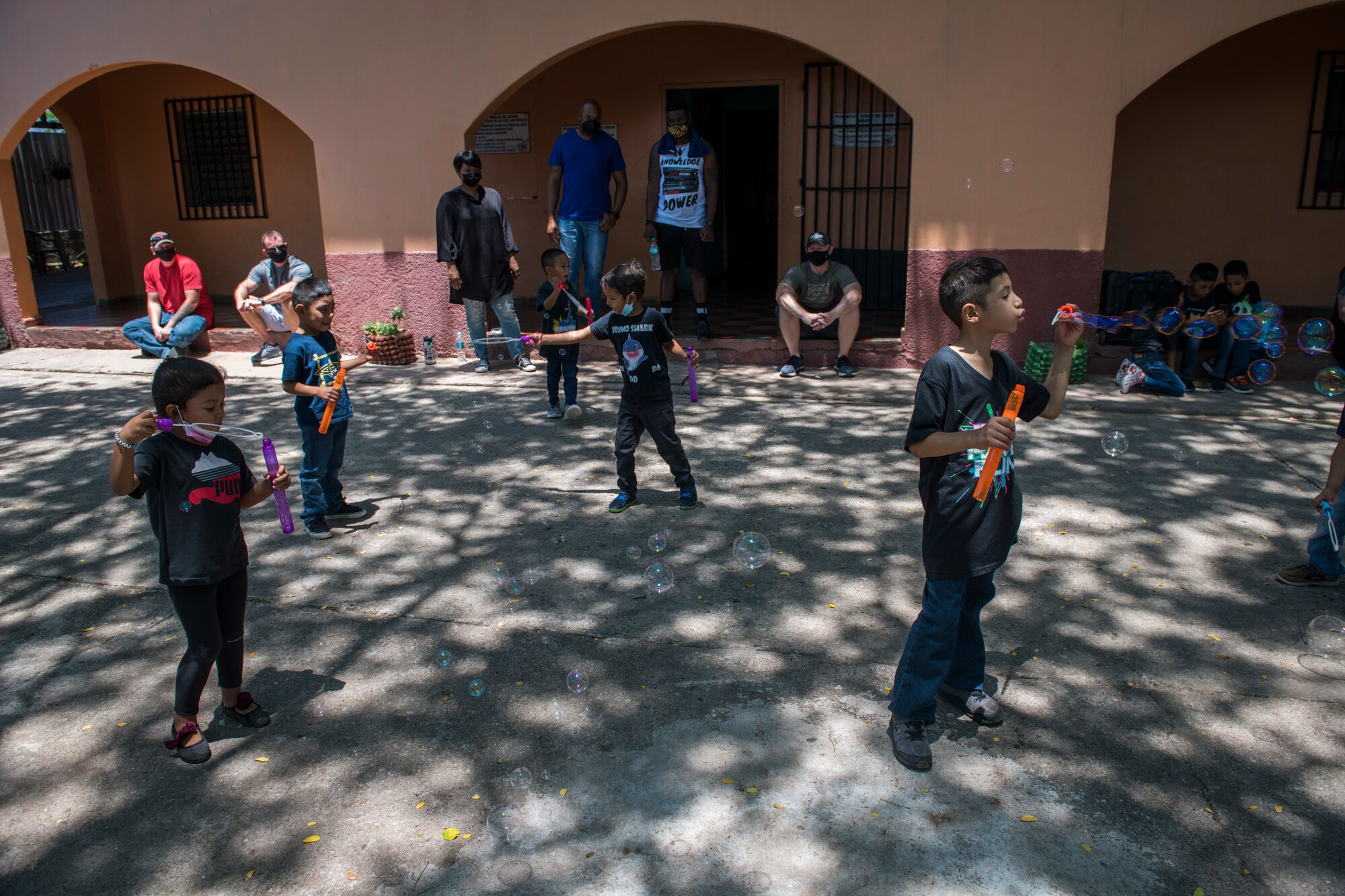 Children at the Children of Love Foundation Orphanage play with bubbles donated by U.S. Airmen with the 612th Air Base Squadron, Soto Cano Air Base, Honduras, during a visit in La Paz, Honduras, April 25, 2021. Members with the 612th ABS donated clothing, shoes, underwear, and towels in a backpack for each child, as well as toys, soap, toothpaste, and school supplies that were delivered in large boxes to 18 orphans who live at the orphanage. (U.S. Air Force photo by Tech. Sgt. Marleah Cabano)