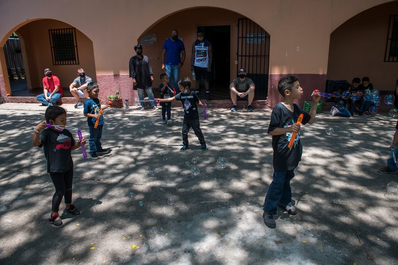 Children at the Children of Love Foundation Orphanage play with bubbles donated by U.S. Airmen with the 612th Air Base Squadron, Soto Cano Air Base, Honduras, during a visit in La Paz, Honduras, April 25, 2021. Members with the 612th ABS donated clothing, shoes, underwear, and towels in a backpack for each child, as well as toys, soap, toothpaste, and school supplies that were delivered in large boxes to 18 orphans who live at the orphanage. (U.S. Air Force photo by Tech. Sgt. Marleah Cabano)