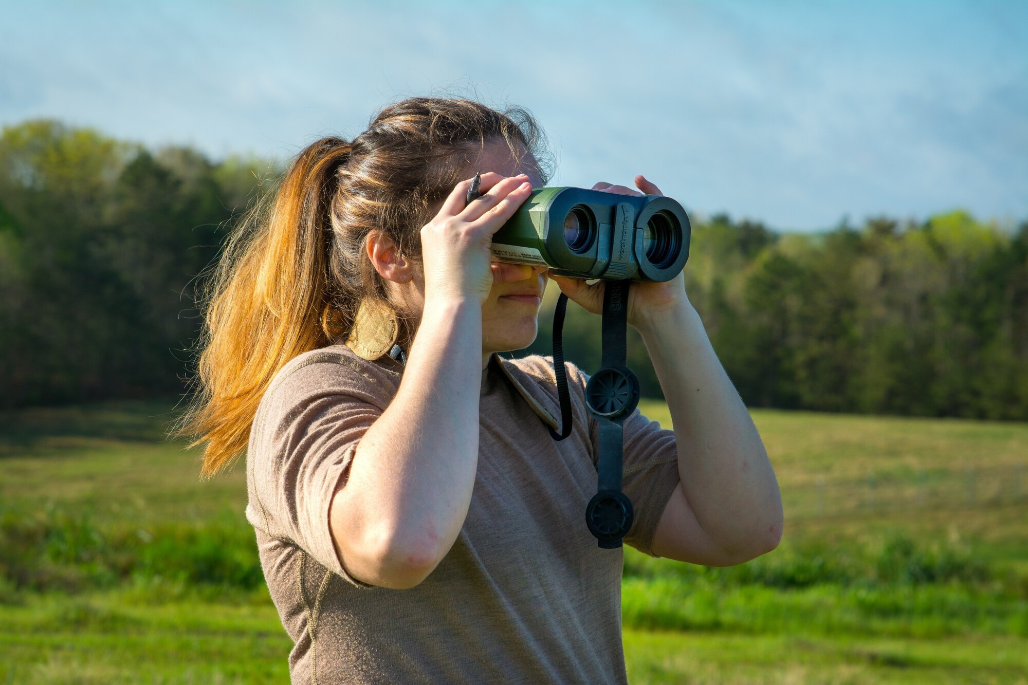 An Airman assigned to the 156th Weather Flight (WF) looks through a laser range finder during training held at the regional training site in New London, N.C., April 11, 2021. The training the 156th WF conducts is conducted a few times a year to keep members current on their annual position qualification.