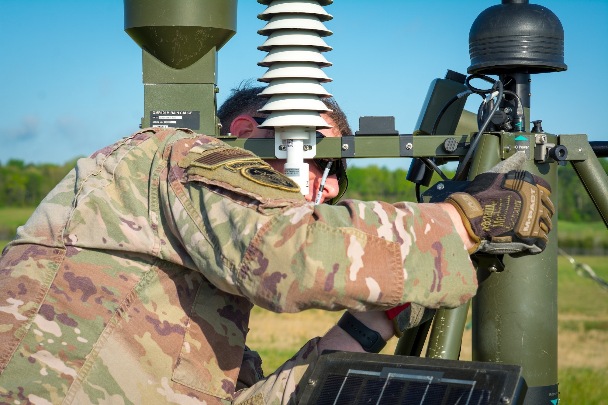 An Airman with the 156th Weather Flight (WF) attaches a power distribution mount to a TMQ-53 portable weather station during training held at the regional training site in New London, N.C., April 11, 2021. The training the 156th WF conducts is conducted a few times a year to keep members current on their annual position qualification.