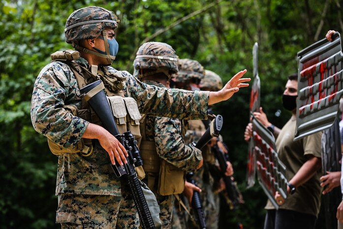 U.S. Marines with 9th Engineer Support Battalion, 3rd Marine Logistics Group, warn notional protestors to move back using appropriate escalation of force tactics during exercise Pacific Pioneer, Okinawa, Japan, April 21, 2021. Pacific Pioneer serves as 9th ESB's Marine Corps Combat Readiness Evaluation as well as an opportunity to demonstrate the ability to establish and sustain expeditionary advanced bases with survivable force protection, practice naval integration, and position long range precision fires and tactical logistics nodes across littoral regions in support of naval operations. 3rd MLG, based out of Okinawa, Japan, is a forward deployed combat unit that serves as III MEF’s comprehensive logistics and combat service support backbone for operations throughout the Indo-Pacific area of responsibility.