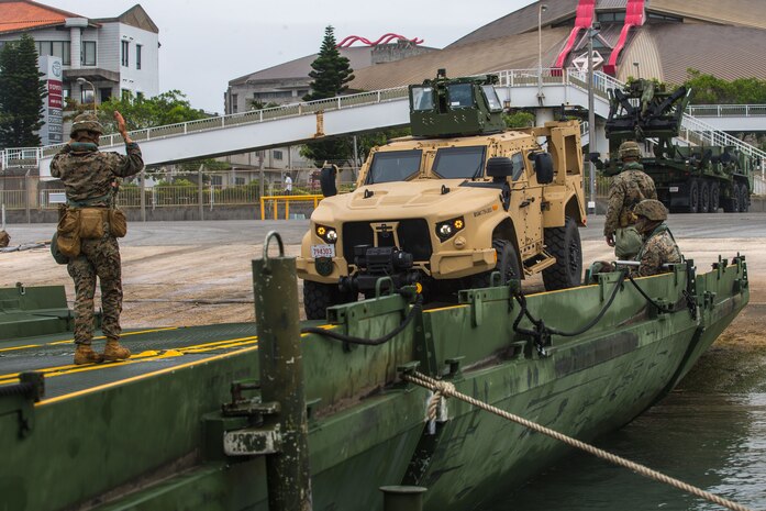 U.S. Marines with 9th Engineer Support Battalion and Navy Seabees with Naval Mobile Construction Battalion 4 load a Joint Light Tactical Vehicle onto an improved ribbon bridge during exercise Pacific Pioneer, Naha Port, April 21, 2021. Pacific Pioneer serves as 9th ESB’s Marine Corps Combat Readiness Evaluation as well as an opportunity to demonstrate the ability to sustain expeditionary advanced bases with survivable force protection, practice naval integration, and position long range precision fires and tactical logistics nodes across littoral regions in support of naval operations.