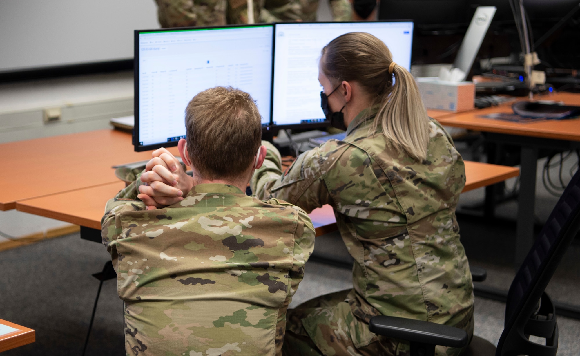 Staff Sgt. Amber Warner and Senior Airman Frederic Borries, 52nd Communication Squadron, participate in the USAFE-led cyber exercise, Tacet Venari, at Ramstein Air Base, Germany, April 22, 2021. Tacet Venari is Latin for Silent Hunt, which describes the goal of the exercise: to hunt for adversaries within USAFE-AFAFRICA weapons systems. The exercise is one of several DoD-wide efforts to provide mission assurance and enhance command and control by providing warfighters the skills needed to deliver defensive cyber operations. (U.S. Air Force photo by 1st Lt. Hannah Durbin)