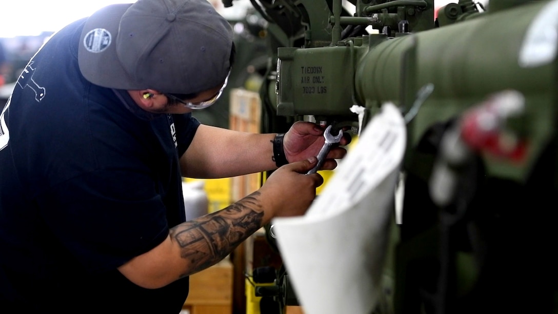 A mechanic works on a military vehicle.