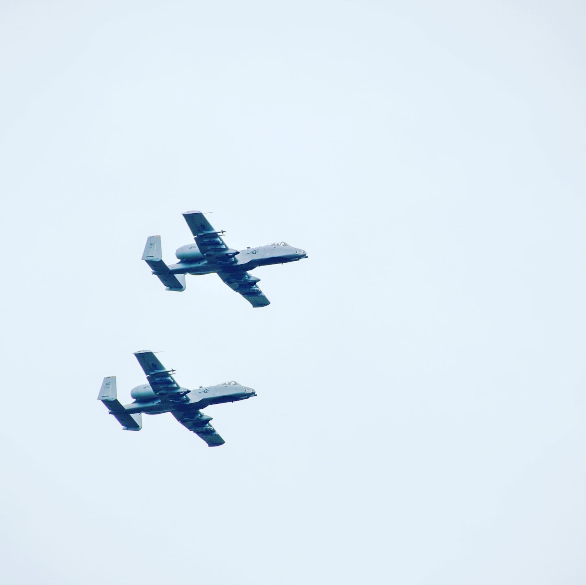 Two A-10s fly in formation.