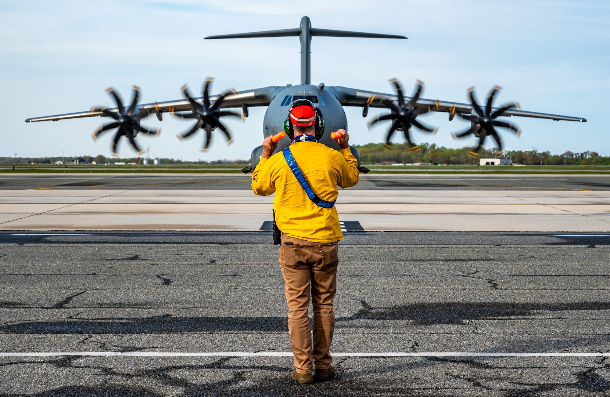 A 436th Maintenance Squadron member marshals a German air force A-400M Atlas as part of a foreign military sales mission at Dover Air Force Base, Delaware, April 19, 2021. Germany is a key NATO ally, helping to strengthen regional security and encourage peace and unity in Europe. Dover AFB’s FMS mission supports approximately $3.5 billion worth of equipment annually. (U.S. Air Force photo by Senior Airman Christopher Quail)