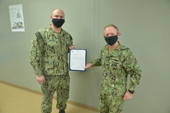 GREAT LAKES, Ill. (March 8, 2021) Surface Warfare Engineering School Command Great Lakes Commanding Officer Cmdr. Shawn Gibson took great pleasure in advancing Machinery Repairman Corbin Golyer to first class petty officer utilizing the Meritorious Advancement Program (MAP) during a ceremony March 8. MAP is designed to recognize superior performance and authorizes commanding officers to advance the best and most deserving E-3 through E-5 Sailors to the next higher pay grade. (U.S. Navy photo by Brian Walsh/Released)