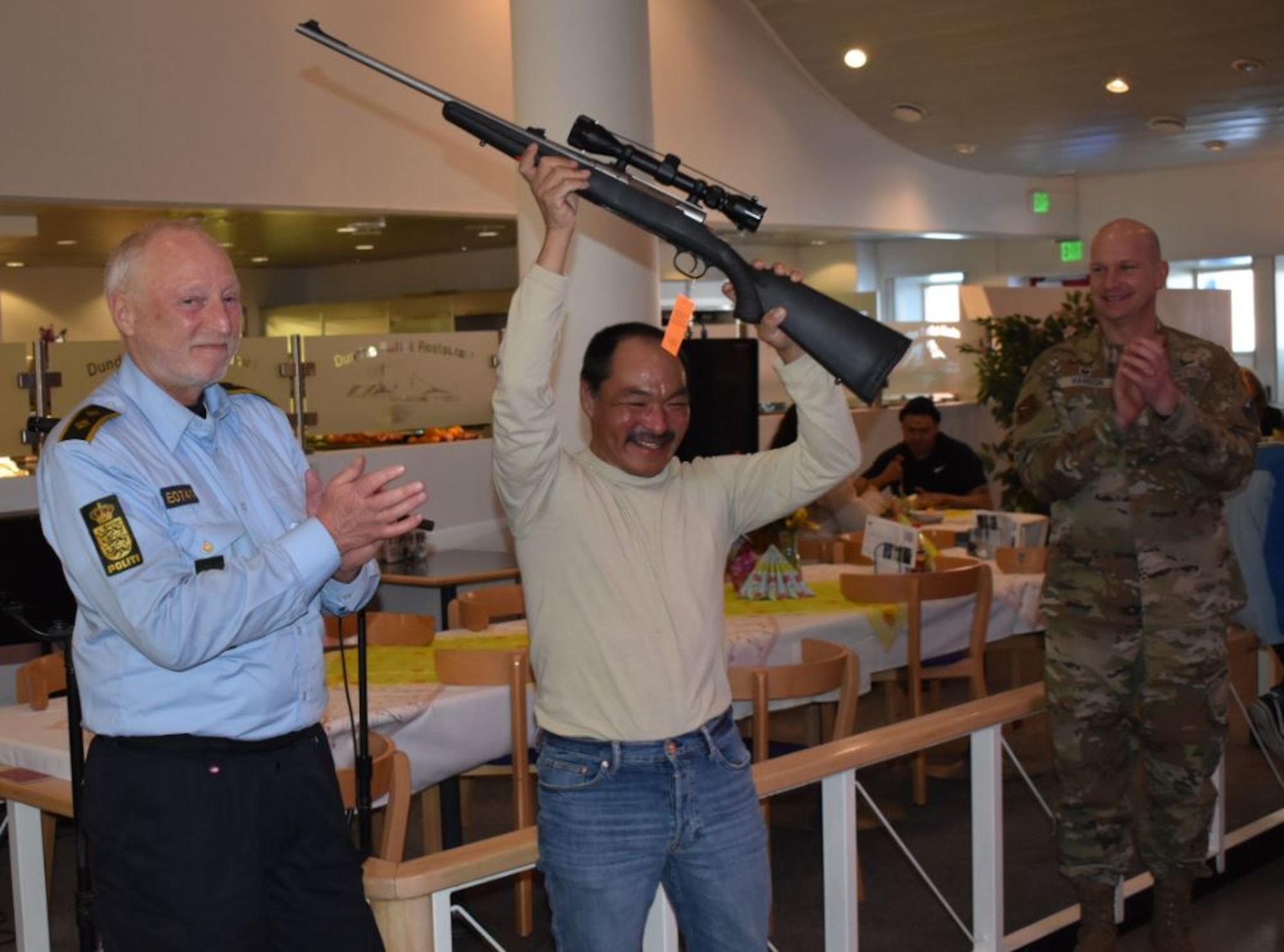 Men smiling with a gun
