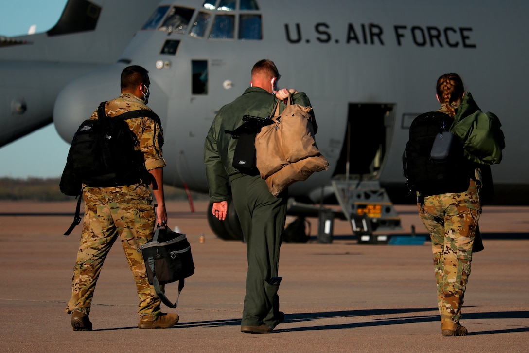 Aircrew members with the 39th Airlift Squadron walk toward a C-130J Super Hercules aircraft on the flightline at Dyess Air Force Base, Texas, Dec. 9, 2020. The U.S. Army Engineering and Support Center, Huntsville, considered an expert in Energy Savings Performance Contracts for Department of Defense service branches, recently awarded an ESPC to upgrade to newer energy efficiency systems there saving the base more than $4.5 million annually.