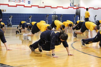 GREAT LAKES, Ill. (March 8, 2021) Training Support Center (TSC) Great Lakes Command Fitness Leaders (CFL) and fitness specialists implementing physical fitness efforts following pause due to COVID 19. Physical training will be conducted, adhering to virus mitigation rules, by CFL and TSC staff volunteers utilizing Navy Operational Fitness and Fueling Series (NOFFS) and authorized Navy Fitness routines.  (U.S. Navy photo by FCSA Elizabeth Jordan /Released)