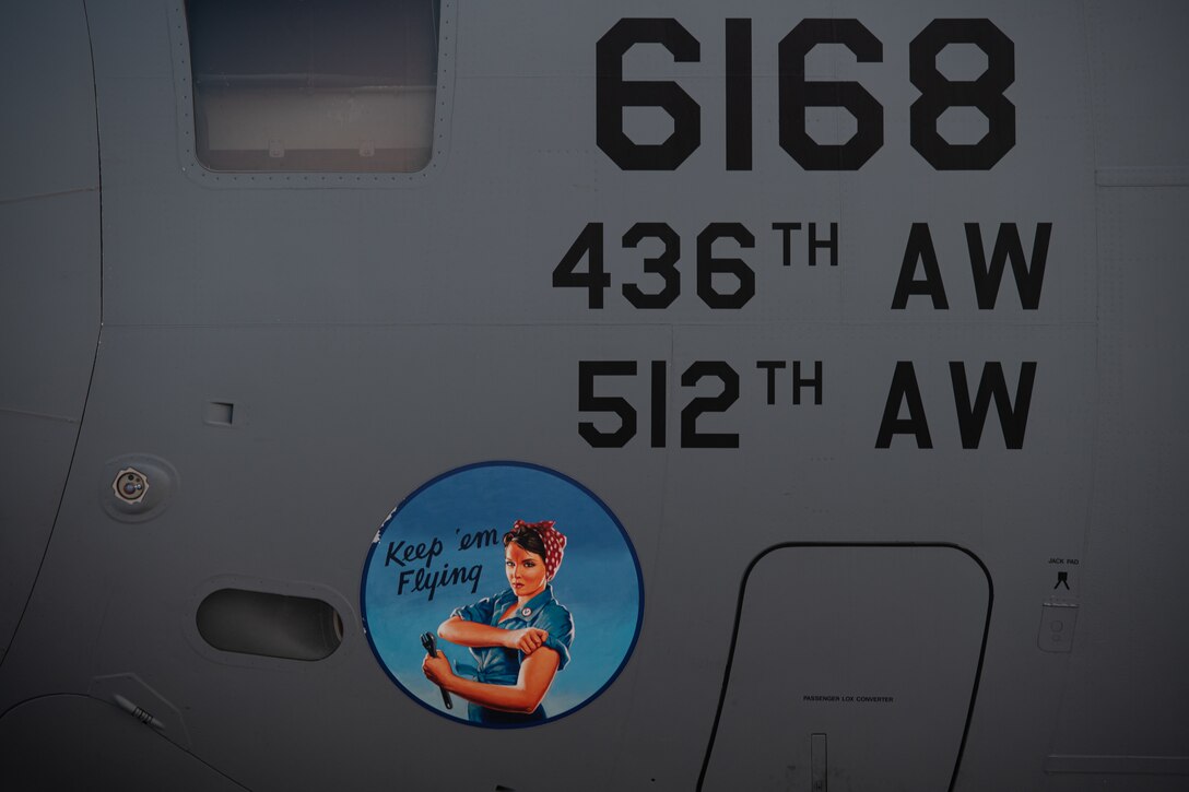 Nose art depicting a female maintainer is displayed on a C-17 Globemaster III at Dover Air Force Base, Delaware, April 23, 2021. Aircraft nose art dates back to World War I, with its golden age occuring during World War II. Nose art continues today as an homage to aviation heritage. (U.S. Air Force photo by Senior Airman Marco Gomez)