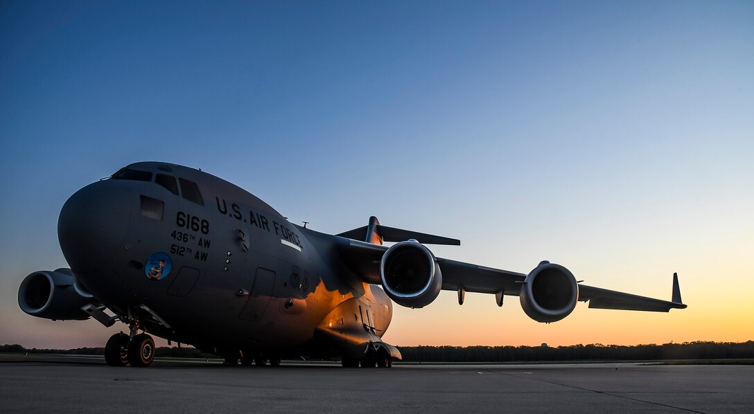 The sun rises over a C-17 Globemaster III aircraft on the flight line at Dover Air Force Base, Delaware, April 23, 2021. The C-17 Globemaster III is the most flexible cargo aircraft to enter the airlift force. The aircraft can perform tactical airlift and airdrop missions and transport litters of ambulatory patients during aeromedical evacuations. (U.S. Air Force photo by Airman 1st Class Stephani Barge)