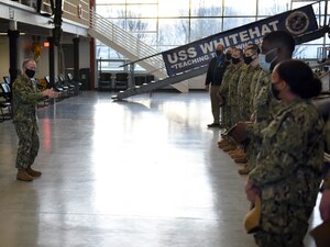 GREAT LAKES, Ill. (Apr. 1, 2021)  Surface Warfare Engineering School Command (SWESC) Great Lakes Commanding Officer Cmdr. Shawn Gibson talked to the staff at Boatswain’s Mate A School and Surface Common Core during a ball capping ceremony held at the USS Whitehat, were SWESC officially completed the transition of the schools from Center for Surface Combat Systems Unit Great Lakes. (U.S. Navy photo by Matt Mogle/Released)