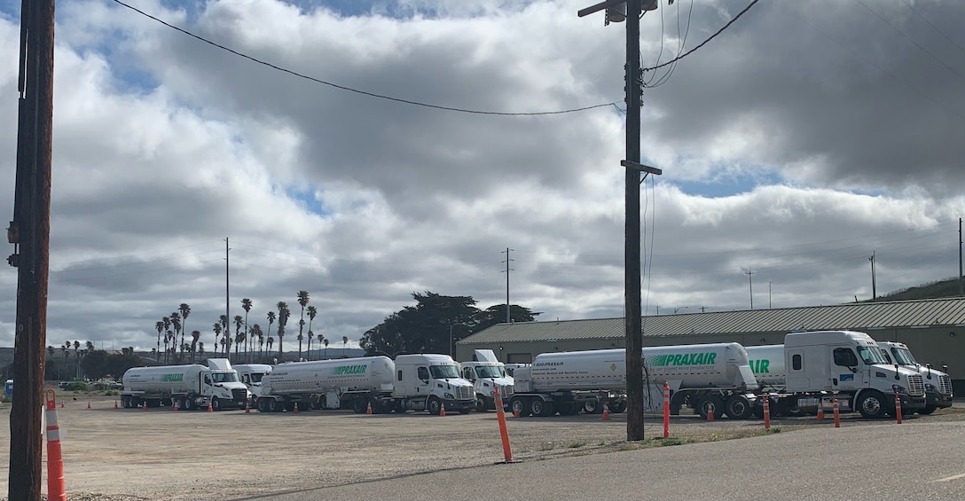 Trucks containing liquid oxygen lined up back to back