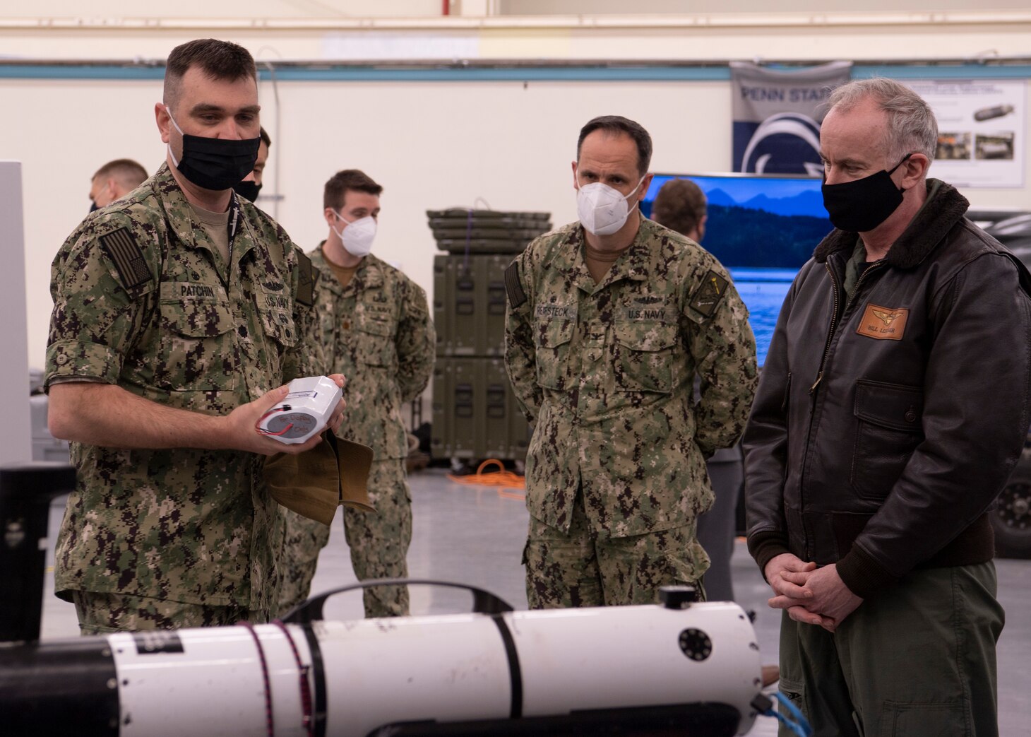 Cmdr. Rob Patchin, commanding officer of Unmanned Undersea Vehicle Squadron (UUVRON) 1, demonstrates battery endurance of a small-class unmanned undersea vehicle to Capt. Lincoln Reifsteck.