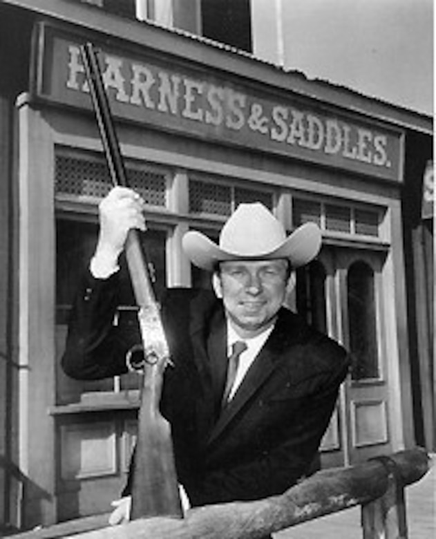 A cowboy actor poses for a photo.