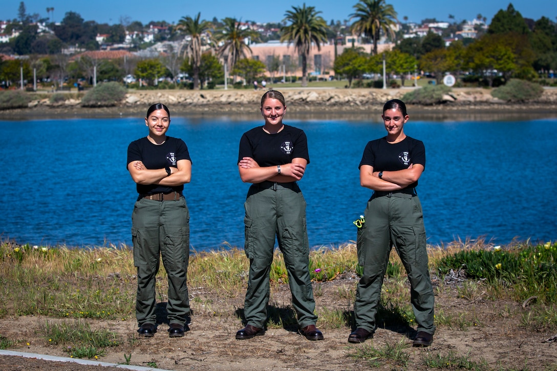 U.S. Marine Corps Sgts. Katrina Jimenez and Cori Barney, and Lance Cpl. Kyra Cherry, aircraft rescue and firefighting Marines with Aircraft Rescue and Fire Fighting unit, Headquarters and Headquarters Squadron, Marine Corps Air Station Miramar, pose for a photo after volunteering during the San Diego Fire-Rescue Department Girls Empowerment Camp in San Diego, California, April 18, 2021.  The two-day camp was an opportunity for kids of all genders to build confidence, make new friends, and work with professional firefighters while learning some of the skills they use during their careers.  (U.S. Marine Corps photo by Lance Cpl. Krysten Houk)