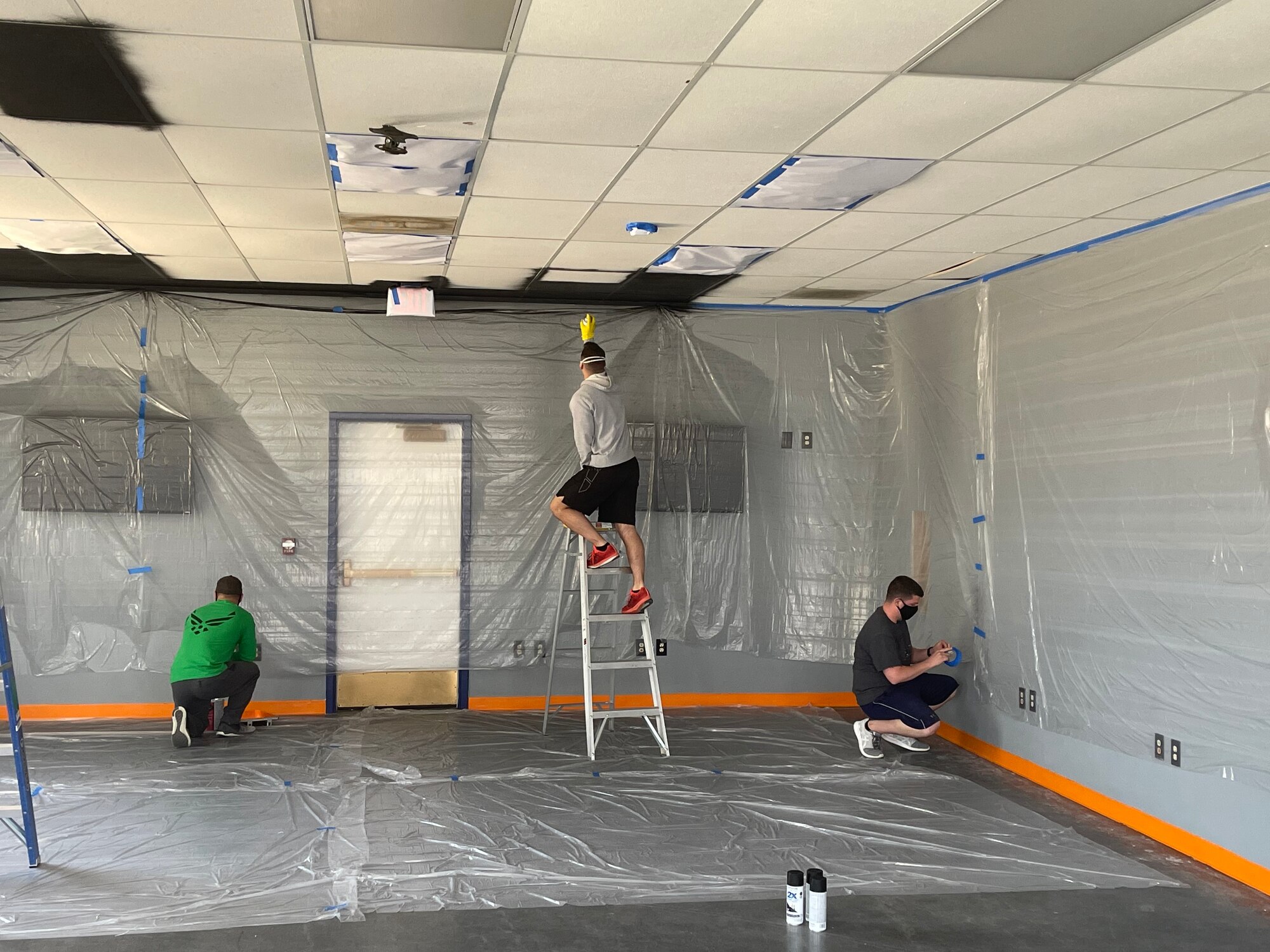 Edwards Air Force Base Airman Leadership School cadre putting the final touches of paint in the student resource center prior to moving in furniture and fixtures at Edwards Air Force Base, California. (Air Force photo by Danny Bazzell)