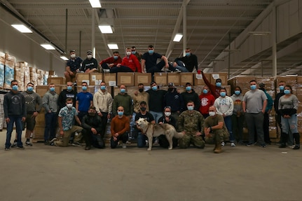 Members of the Task Force Distribution team pose for a photo at the Concord warehouse, April 23, 2021.