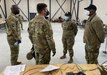 Army Capt. Triada Cross and Master Sgt. Lonnell Thompson, the Base Operating Support-Integrator cell commander team in Tapa, Estonia, for DEFENDER-Europe 21, greet the commander and command sergeant major from the 405th Army Field Support Brigade, Col. Brad Bane and Command Sgt. Maj. Kofie Primus, at the BOS-I command post at Tapa Barracks. The BOS-I cell relies on the 405th AFSB and its Logistics Civil Augmentation Program for its contracting needs.