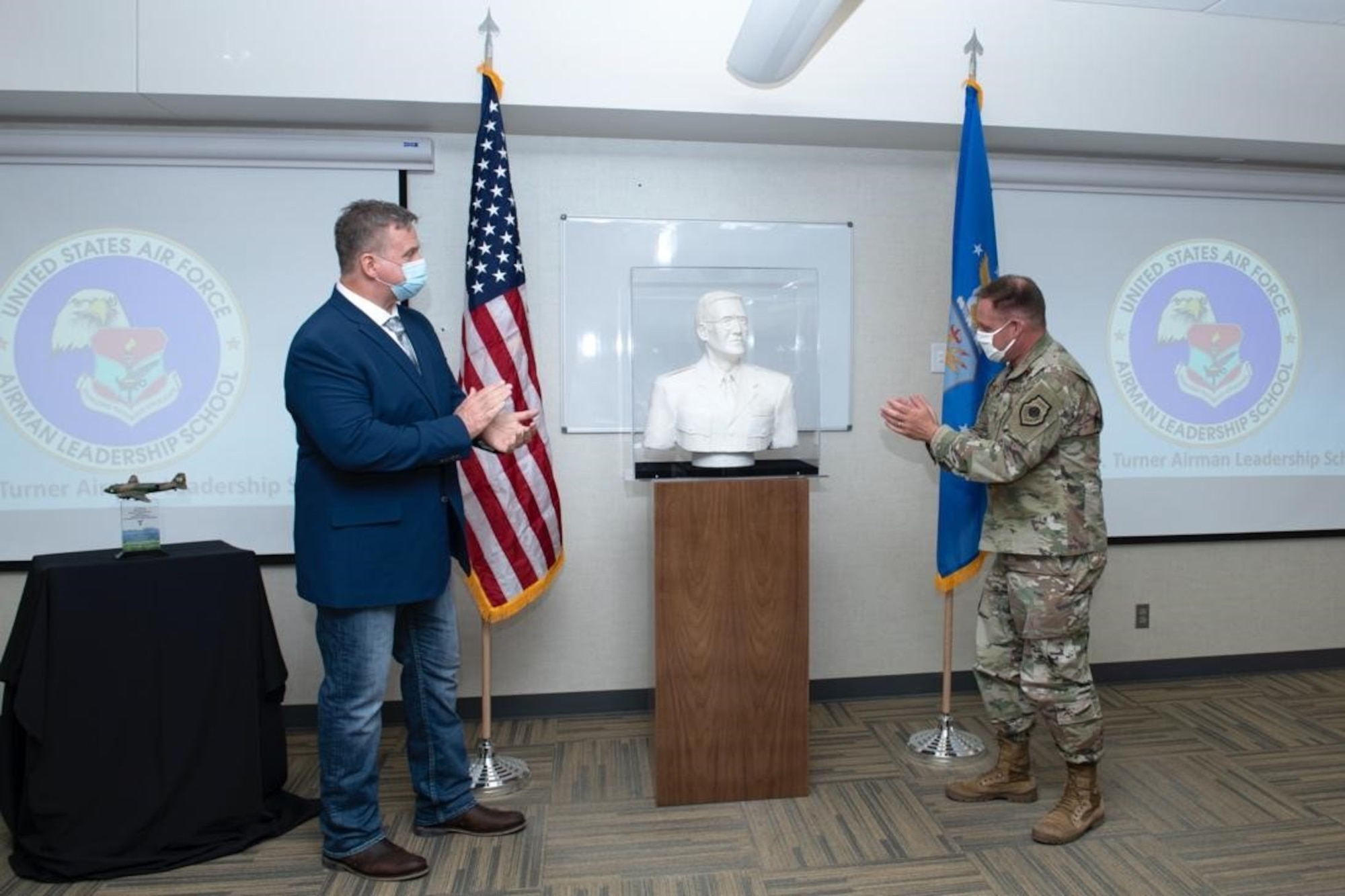 Samuel A. Turner and Col. David Doss, the 28th Bomb Wing commander, unveil the Samuel O. Turner Heritage Sculpture at Ellsworth Air Force Base, S.D., April 20, 2021.