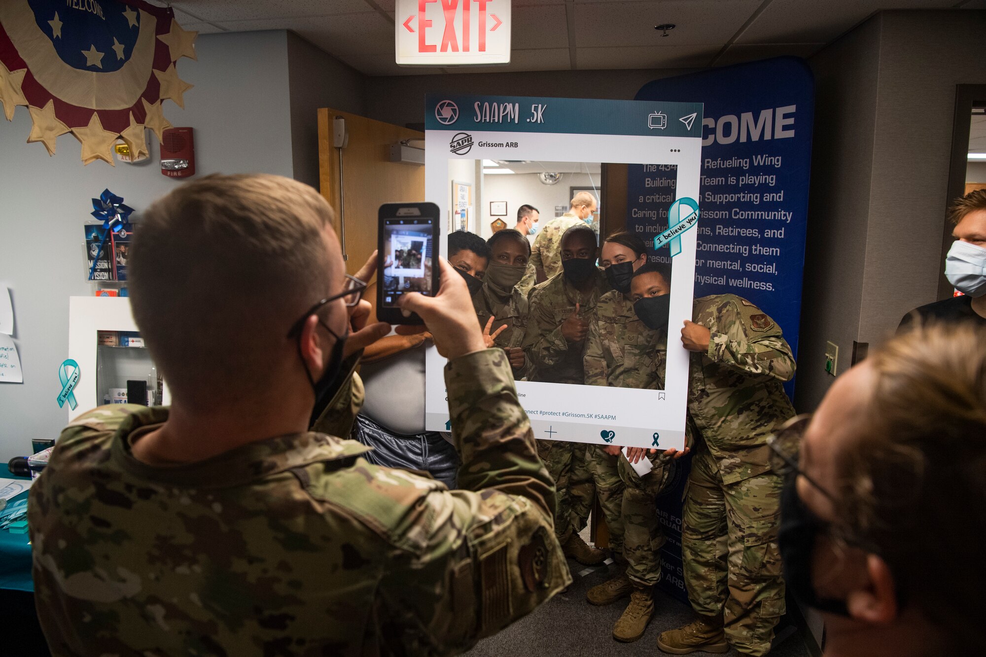 A group of Airmen take a selfie holding a frame at Grissom Air Reserve Base, Indiana, April 10, 2021. The frame promoted Sexual Assault Prevention and Response Month and gave hashtags that people could share on social media to spread awareness. (U.S. Air Force photo by Staff Sgt. Michael Hunsaker)